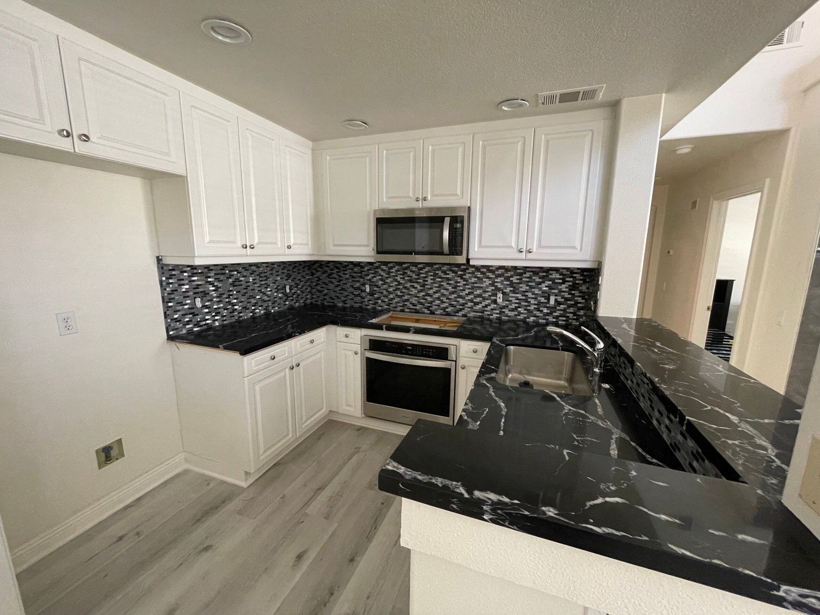 Black galaxy marble countertop with mosaic tile backsplash for kitchen