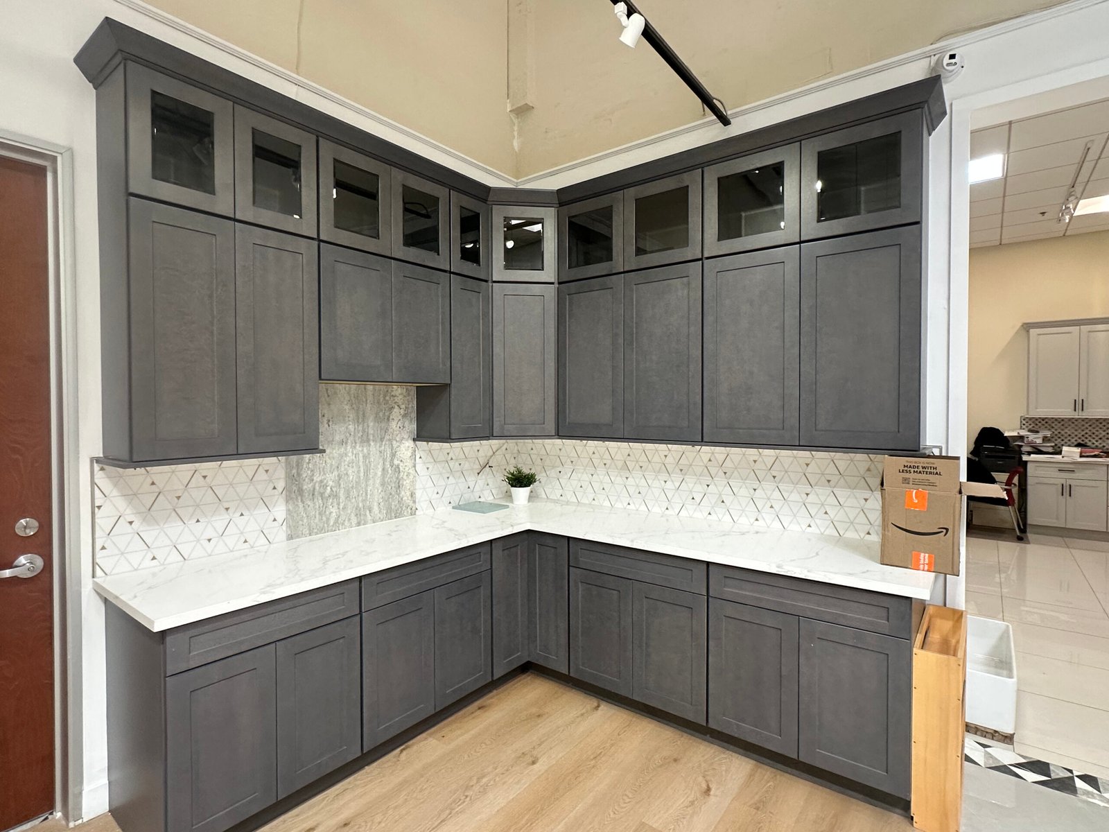 White triangle mosaic backsplash with matching marble countertop.